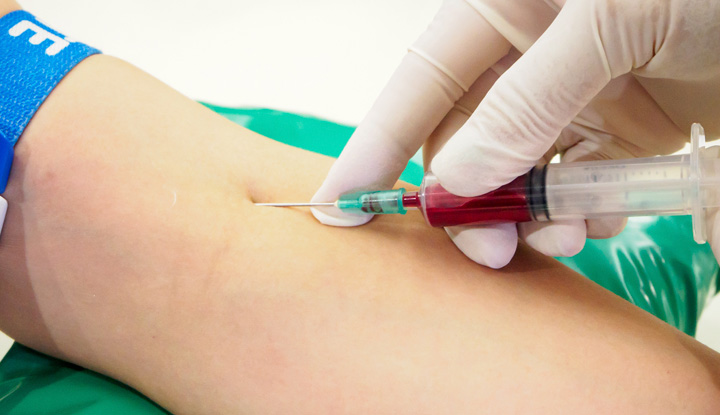 Person giving a blood sample from their inner elbow