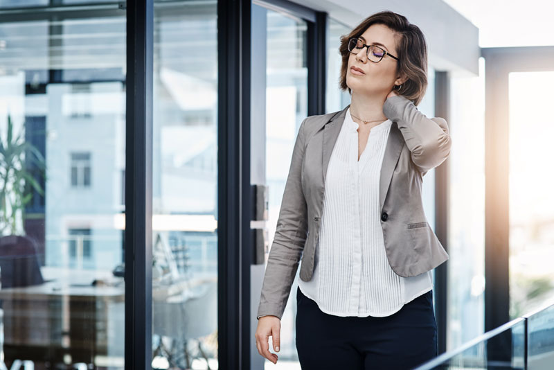 A photo of a person experiencing stiff neck symptoms