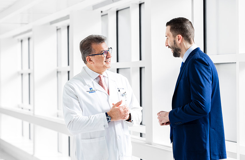2 Cleveland Clinic Caregivers talking in a hallway.